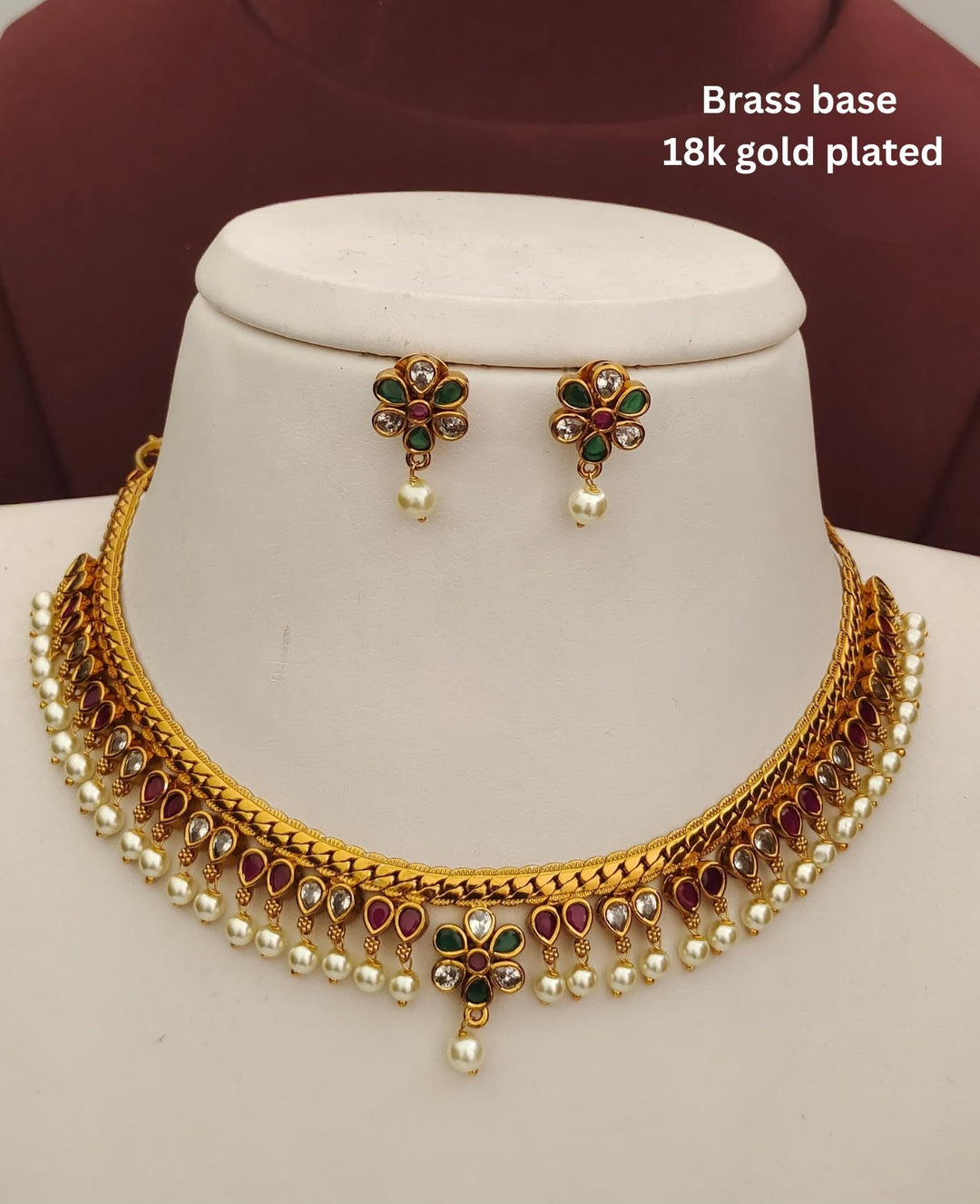 Elegant kids jewellery set with a gold plated necklace, matching earrings, multicolor stones and pearl embellishments.