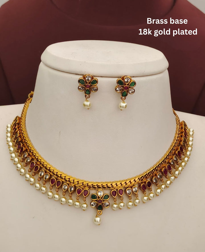 Elegant kids jewellery set with a gold plated necklace, matching earrings, multicolor stones and pearl embellishments.