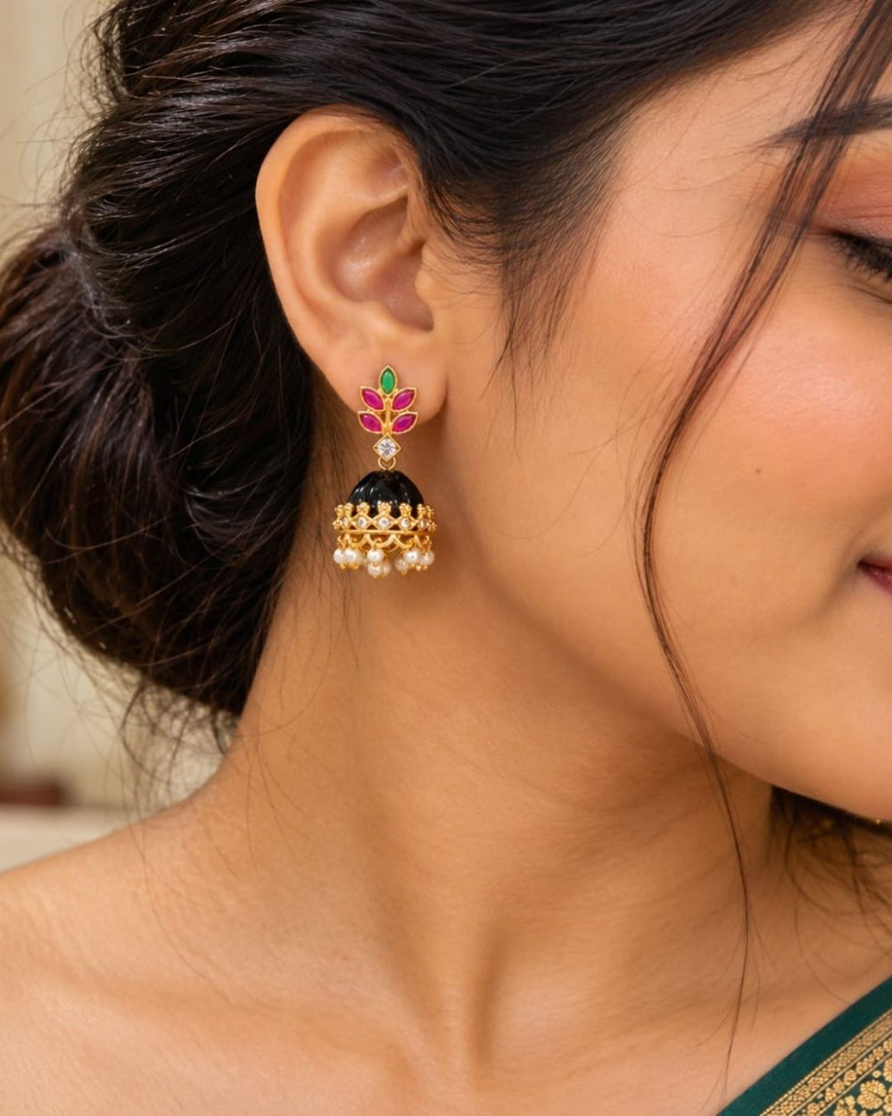 Traditional gold finish jhumka earrings with decorative pink and green leaf motifs, sparkling stones, and pearl hangings with interchangeable color options.