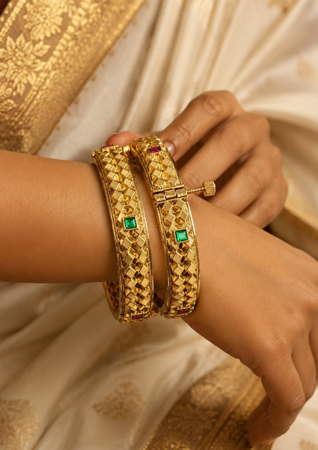 Beautiful gold plated openable bracelet pair featuring a geometric textured pattern, ruby and green stone accents, and elegant craftsmanship. Perfect for daily wear, weddings, festivals, traditional outfits, family functions, and premium gifting.
