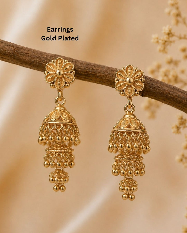 Beautiful traditional gold plated jhumka earrings featuring floral-inspired studs, intricate layered jhumka craftsmanship, decorative patterns, and elegant hanging gold bead accents. Perfect for sarees, festive occasions, weddings, and traditional events.