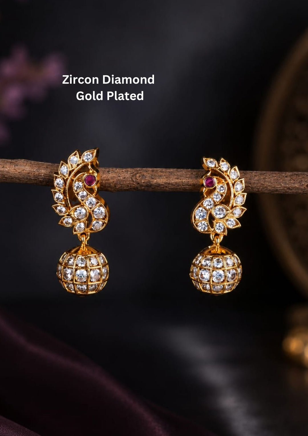 Beautiful Jadau gold plated peacock Jhumka earrings featuring shimmering zircon stones, ruby accents, and a classic matte finish. Perfect for weddings, festive occasions, traditional outfits, and premium gifting.