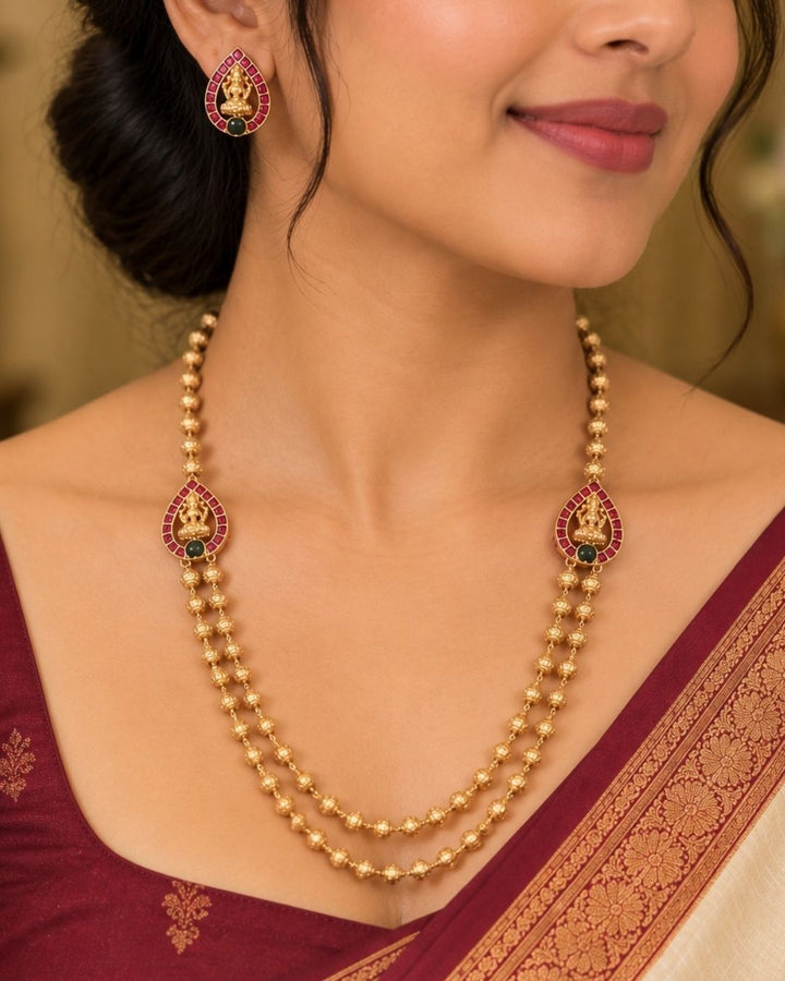 jadau kundan gold plated traditional double layer beads necklace set and in given picture laxmi pendent shows it very clear and it comes with laxmi earrings it is light weight and most south Indian women&