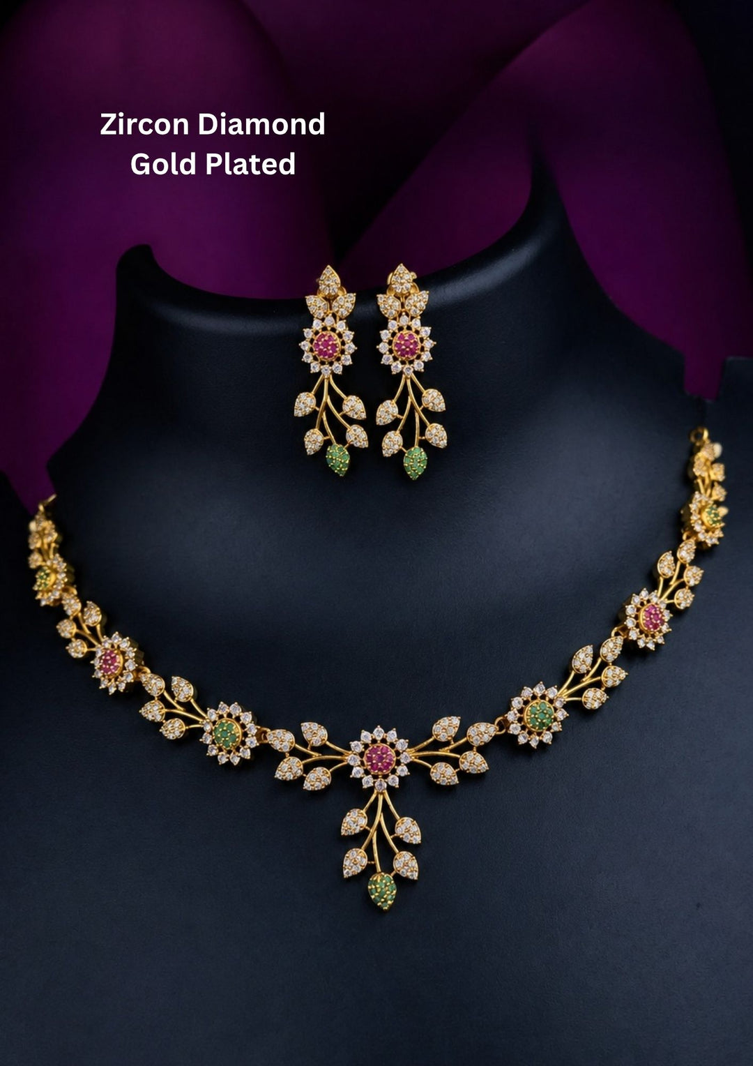 Gold-plated zircon diamond necklace and matching drop earrings The jewelry features gold-tone floral and leaf motifs set with clear stones, pink gemstones, and small green accents. Elegant floral gold plated necklace set with pink, green, and white zircon stones, perfect for weddings, parties, and festive occasions.