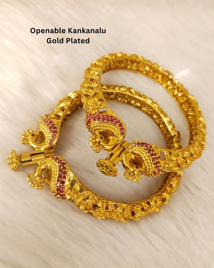 Designer Openable Peacock Gold Plated Kankanalu with floral engraved detailing, ruby-inspired embellishments, intricate craftsmanship, and an elegant hinged design.