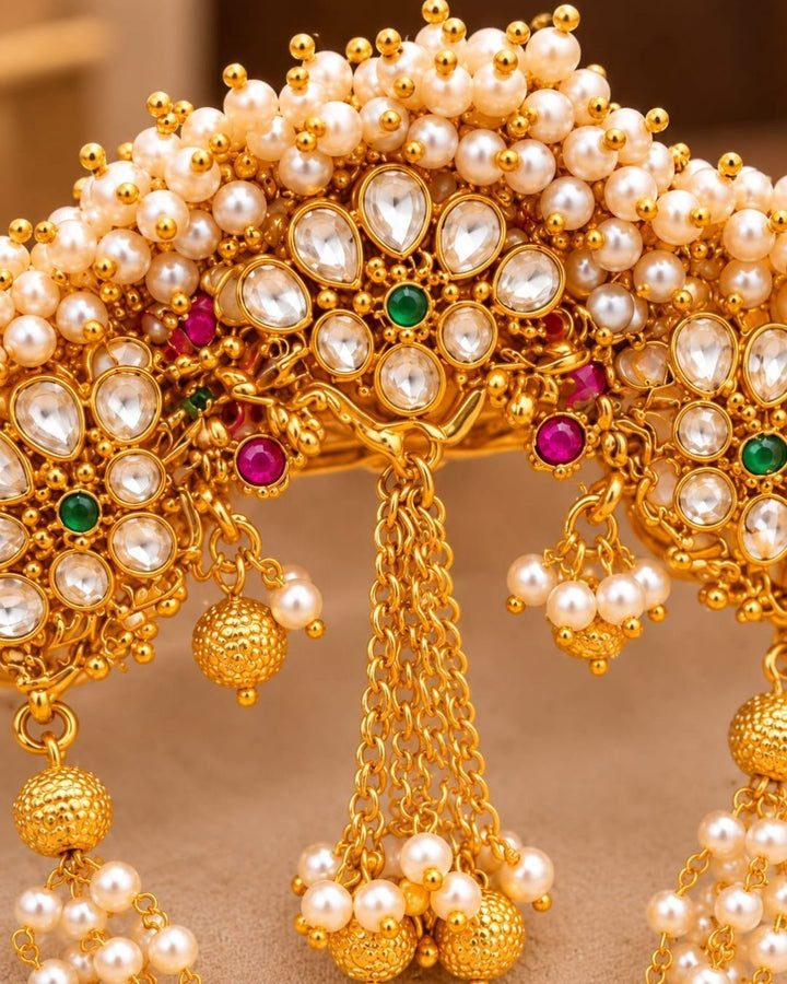 Traditional Indian hair ornament with pearl beadwork, kundan accents, and gold-tone hanging details for festive and bridal hairstyles.