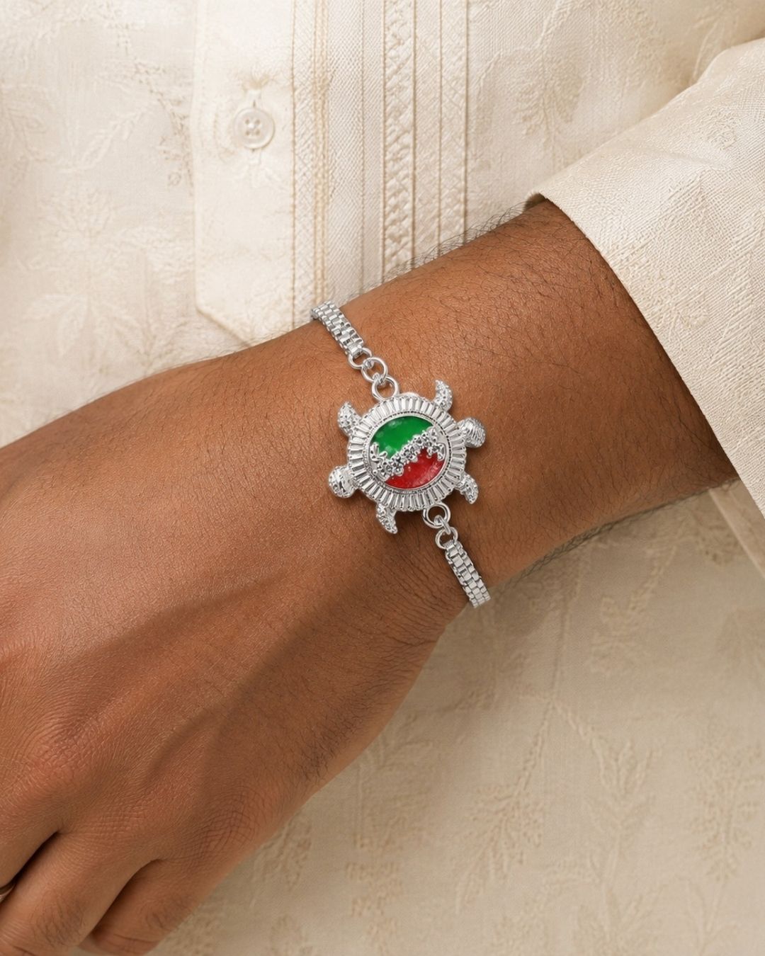 Traditional Silver Plated Turtle Rakhi Bracelet with an intricately crafted turtle design, colorful enamel detailing, crystal embellishments, and a stylish silver-tone chain.