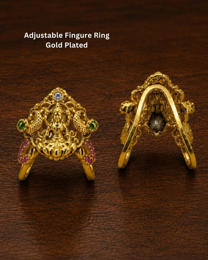 Beautiful Lakshmi Devi gold plated earrings featuring an intricate goddess design, green and ruby-colored stones, and detailed traditional craftsmanship. Perfect for festive occasions, temple visits, traditional outfits, and gifting.
