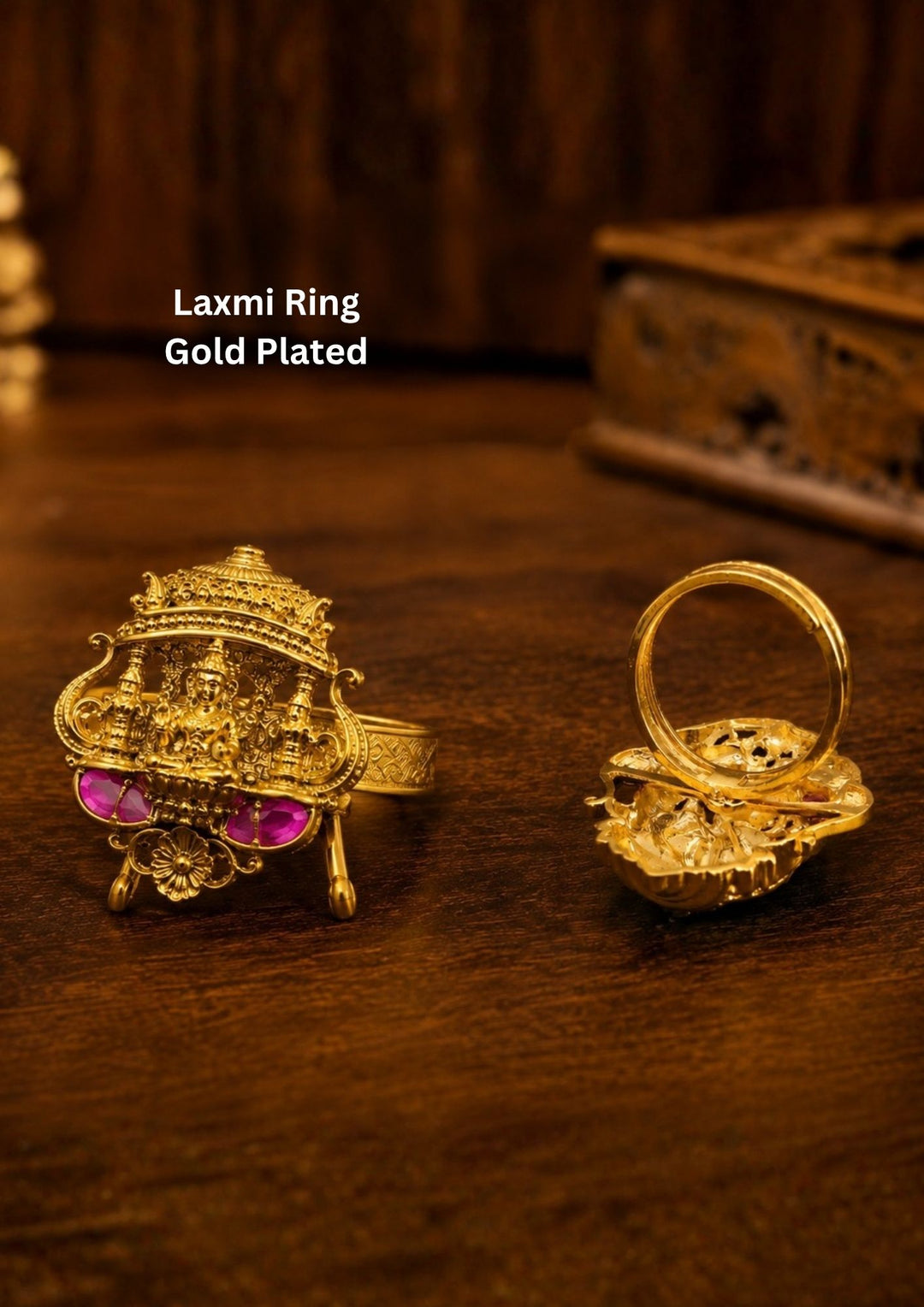 Traditional gold plated laxmi adjustable finger ring featuring an intricate antique-inspired design adorned with ruby pink and emerald green kemp stones. The centerpiece showcases a pear-shaped white kundan stone surrounded by circular stone detailing in a graceful temple jewelry pattern. The adjustable open-back design ensures a comfortable fit while adding an elegant ethnic touch suitable for weddings, festivals and cultural occasions.