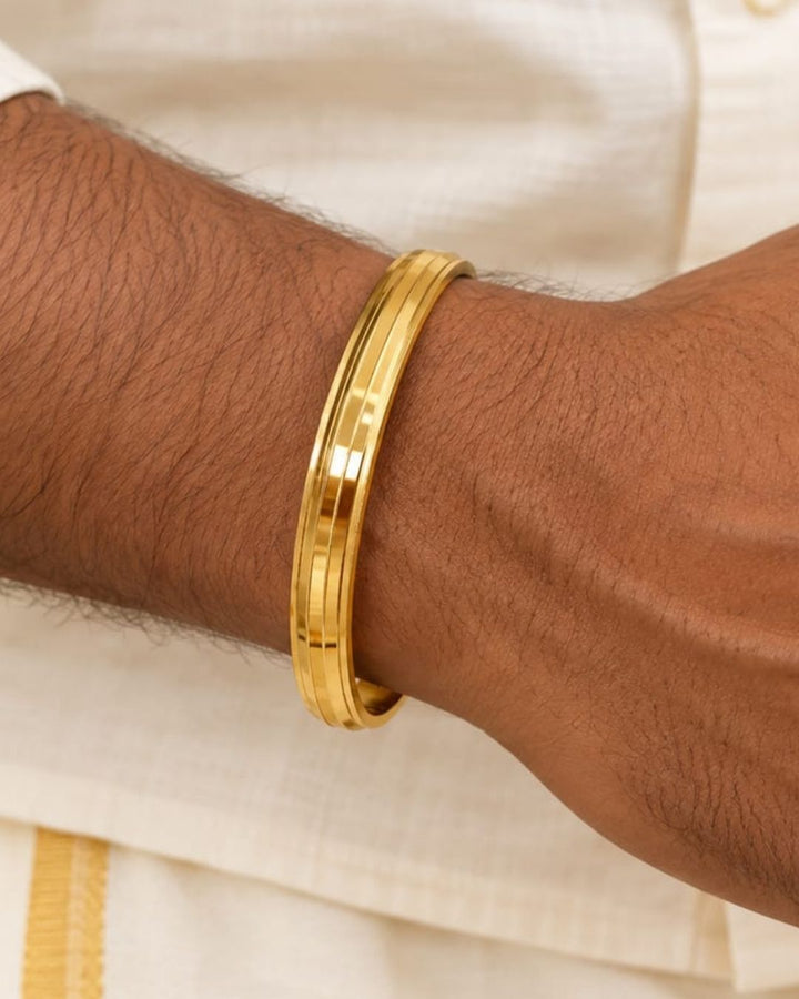Stylish gold plated women’s kada featuring a sleek triple-line design, smooth polished finish, and elegant minimalist look, perfect for daily wear, festive occasions, and modern traditional outfits.
