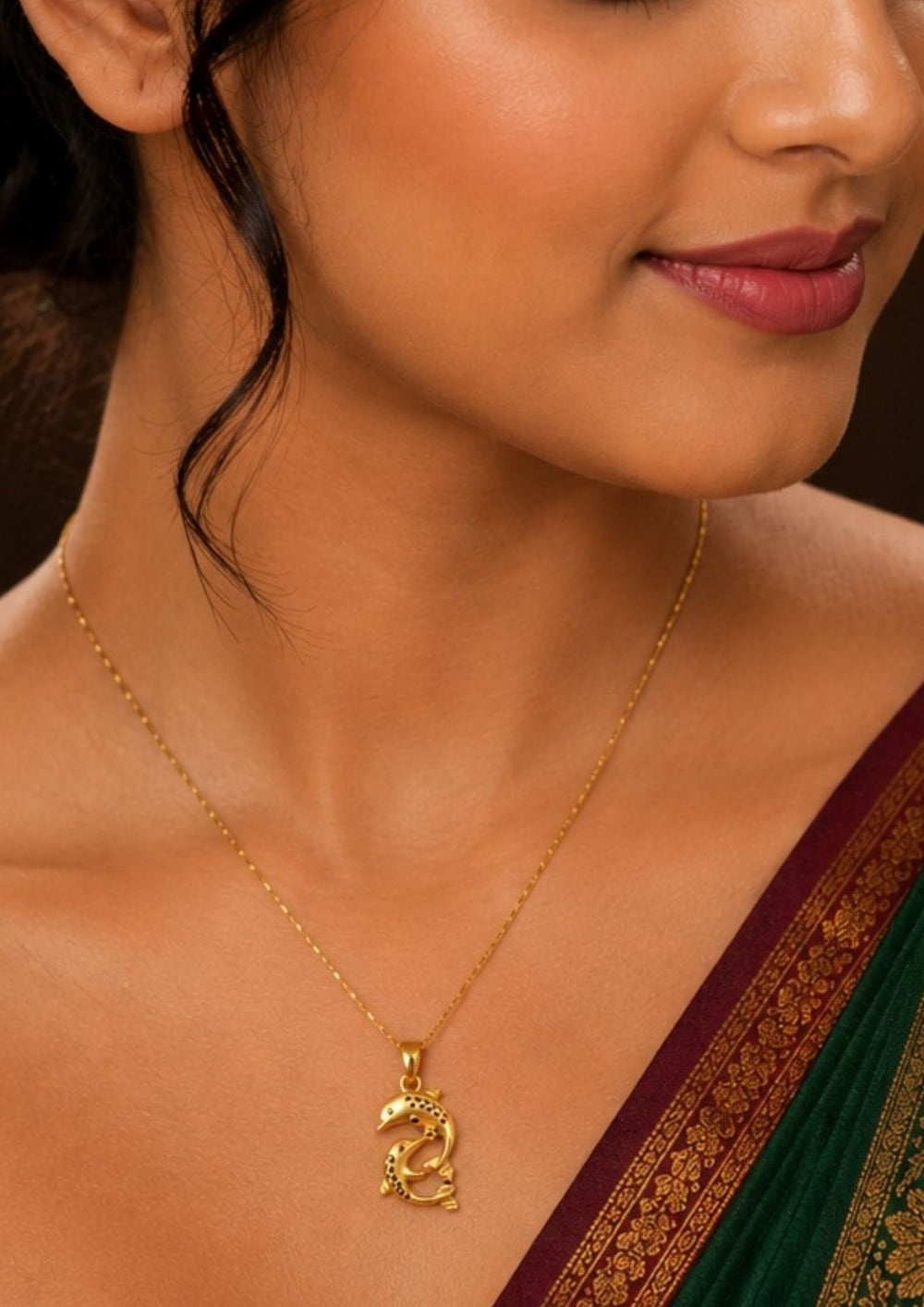 Woman wearing a Two dolphins are depicted in a playful, curved position, forming a loose yin-yang or circular shape. The dolphins feature textured detailing along their backs to give them a shimmering, patterned look.