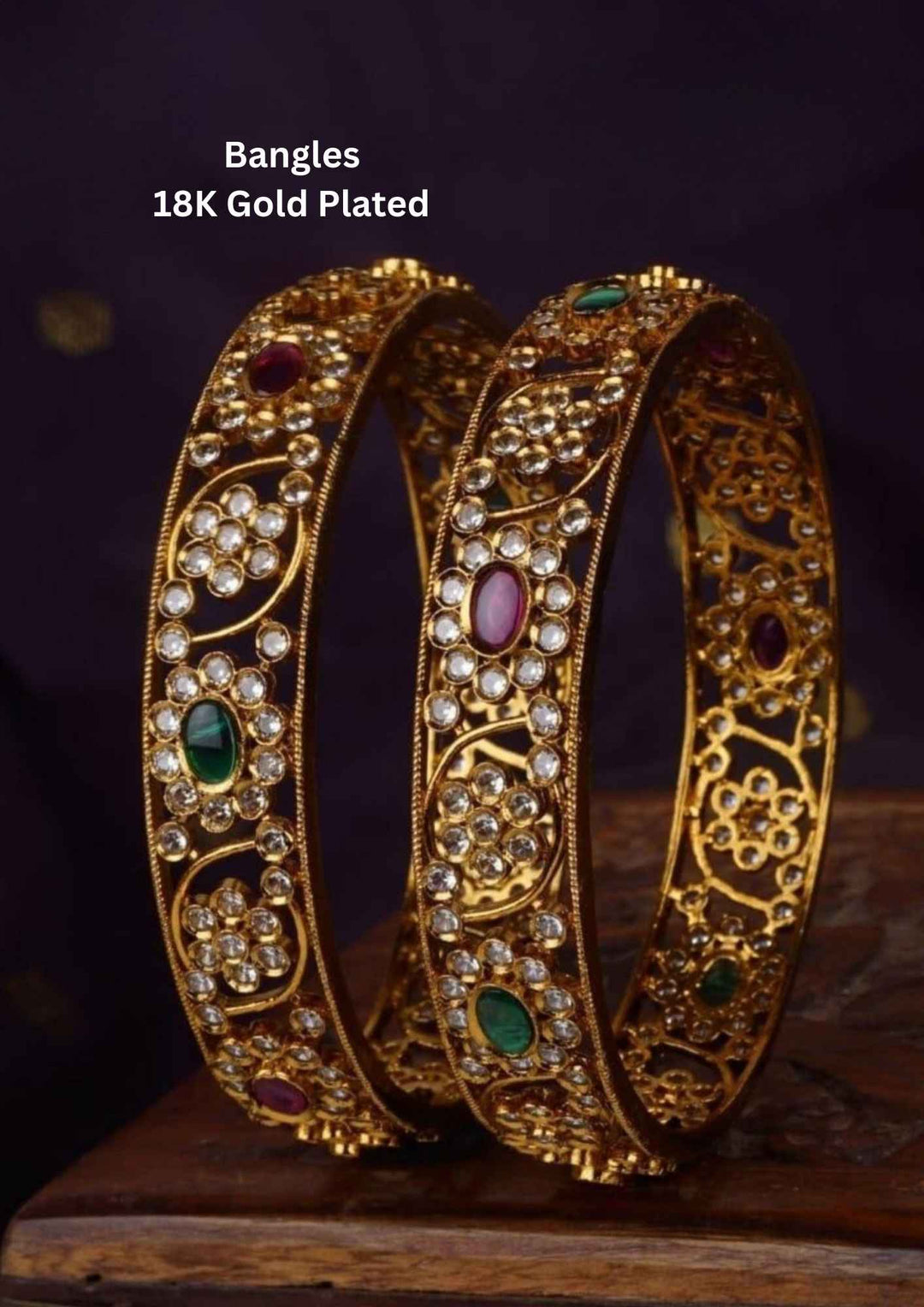 Two gold-plated bangles with gemstones 