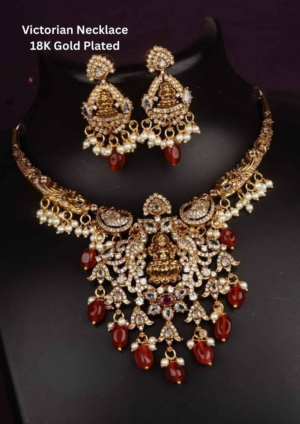 Victorian-style necklace and earrings with gold plating and red stones