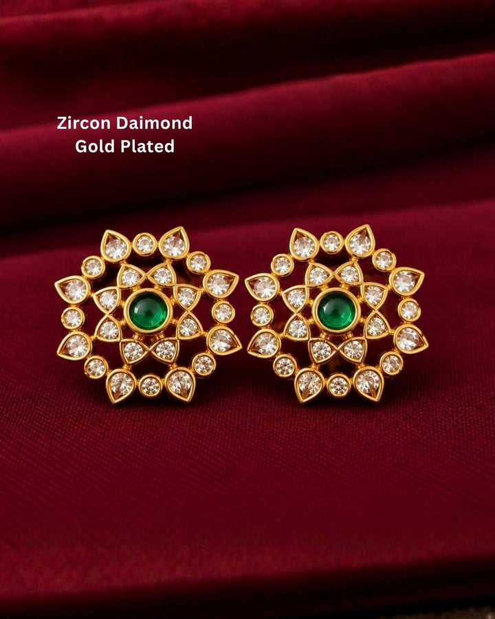 Kundan Gold Plated Polki Red Gemstones Studs design with traditional flower design, used green and red ruby stones and white pearls. These earrings have a gold finish, are lightweight, and comfortable to wear. Perfect for daily wear, pooja, weddings, festivals, functions, and family occasions. 