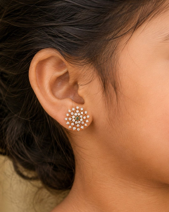 Zircon diamond studs 18K gold plated design with traditional flower design, used green and pink ruby stones and white pearls. These earrings have a gold finish, are lightweight, and comfortable to wear. Perfect for daily wear, pooja, weddings, festivals, functions, and family occasions. They are sweat-proof, anti-fade, skin-friendly, and easy to wear for long hours.