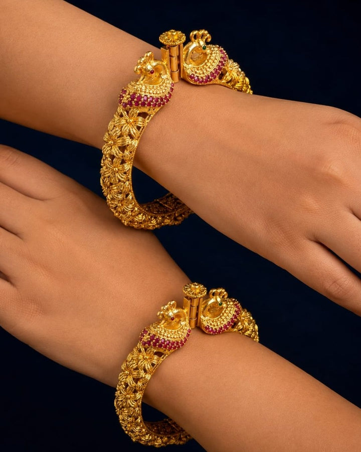 Designer Openable Peacock Gold Plated Kankanalu with floral engraved detailing, ruby-inspired embellishments, intricate craftsmanship, and an elegant hinged design.
