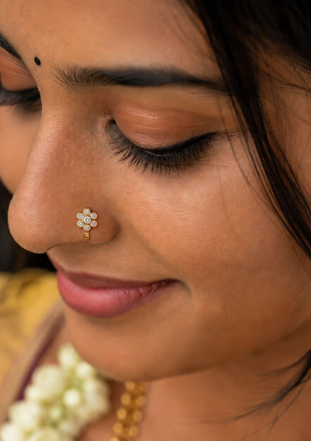 Close-up of a woman's wearing a Gold-plated nose pin design with Floral design using zircon diamonds with back open its perfect for weddings, dailywear and it is antifade color.