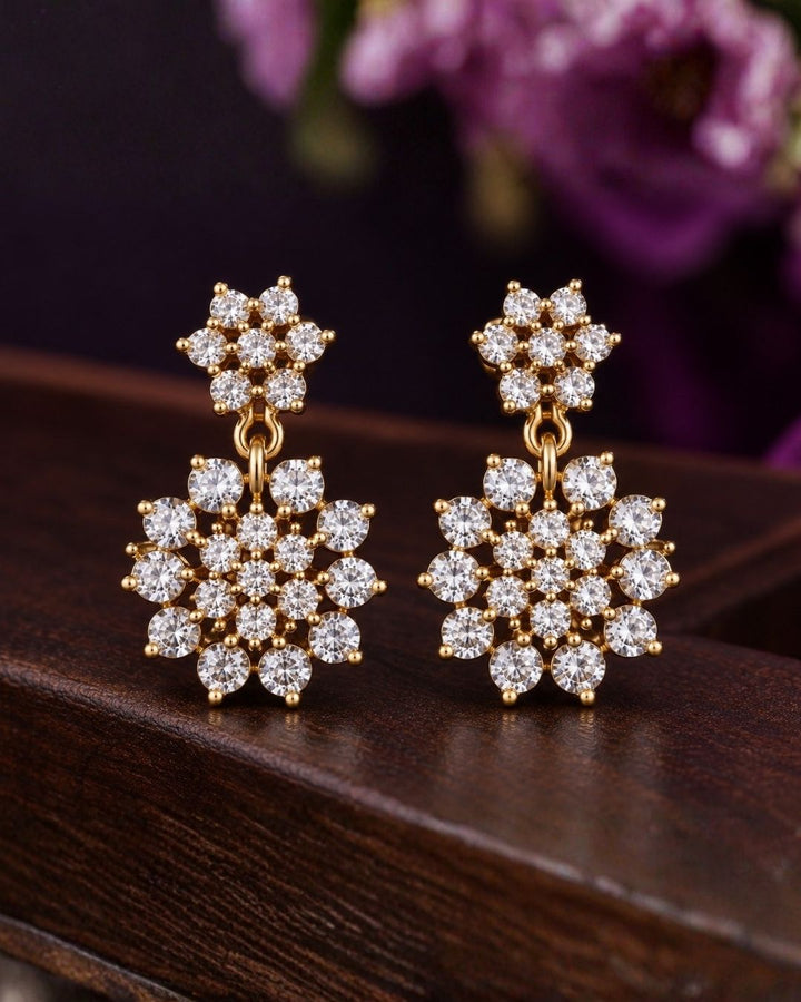 Zircon diamond gold-plated necklace set showcasing an intricate chain linked with tiny floral stone clusters and a beautiful geometric snowflake statement pendant. The matching earrings perfectly mirror the pendant&