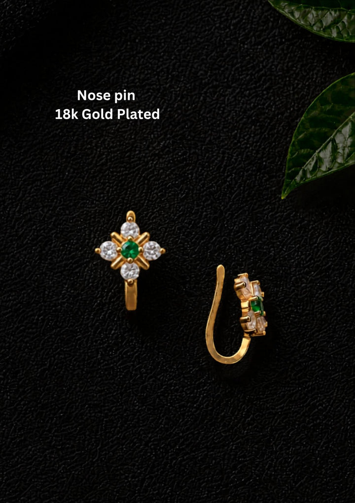 Gold-plated nose pin design with leaf design using zircon diamonds and green gemstone with back open its perfect for weddings, dailywear and it is antifade color.