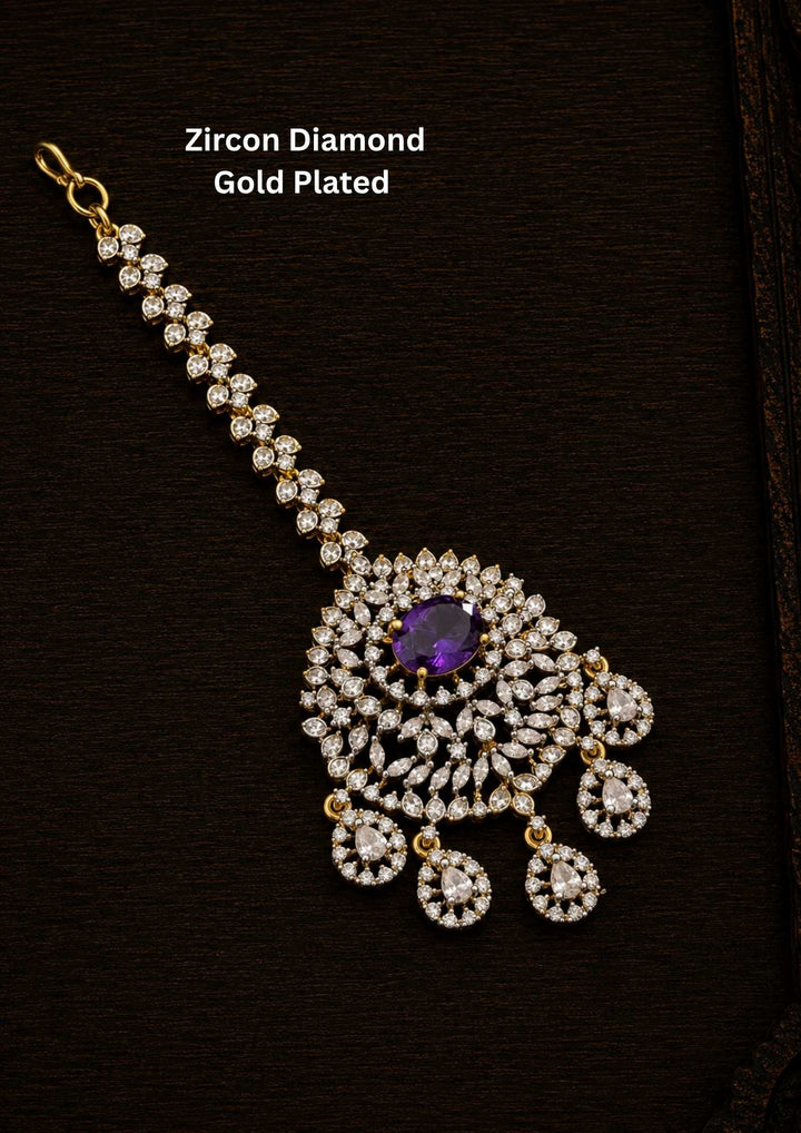 Gold-plated Zircon Diamond Mangtikka (papidi billa) shows in picture clearly how it looks and comes with Purple stone and can be used for weeding's and festivals 