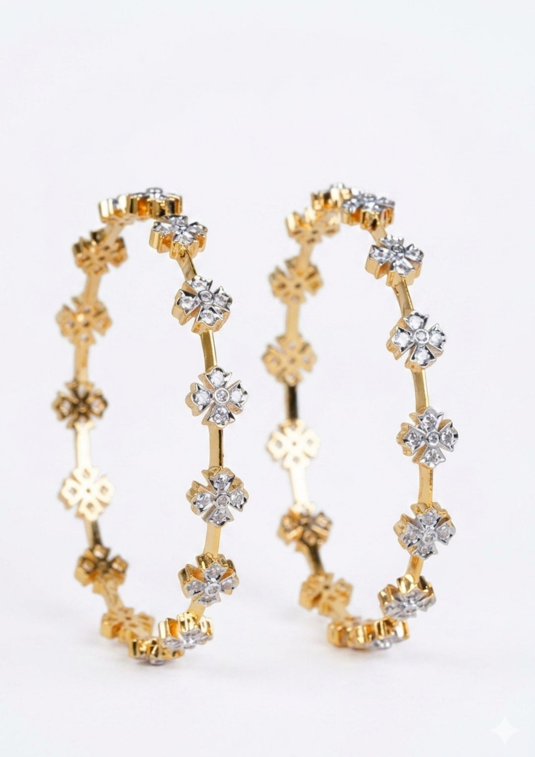 Gold plated bangles with diamond-like stones on a white background gold plated flower bangles come with zircon diamond and in picture shows clearly how it looks looks very classy and simple and ani faded and skin safe and can be used for daily ware, office ware and festivals