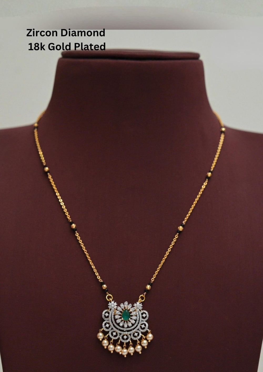 Modern Zircon Diamond gold plated mangalsutra necklace The design features a delicate gold link chain transitioning into sections of traditional small black beads on both sides. The central pendant showcases a sleek, contemporary curved u-shape and a stylized butterfly or floral motif encrusted with sparkling white cubic zirconia stones. This elegant neckpiece perfect for daily wear, office wear, and casual outfits.