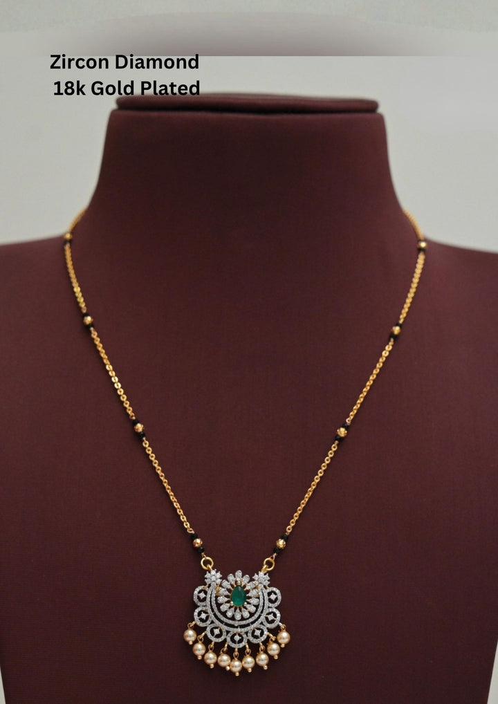 Modern Zircon Diamond gold plated mangalsutra necklace The design features a delicate gold link chain transitioning into sections of traditional small black beads on both sides. The central pendant showcases a sleek, contemporary curved u-shape and a stylized butterfly or floral motif encrusted with sparkling white cubic zirconia stones. This elegant neckpiece perfect for daily wear, office wear, and casual outfits.