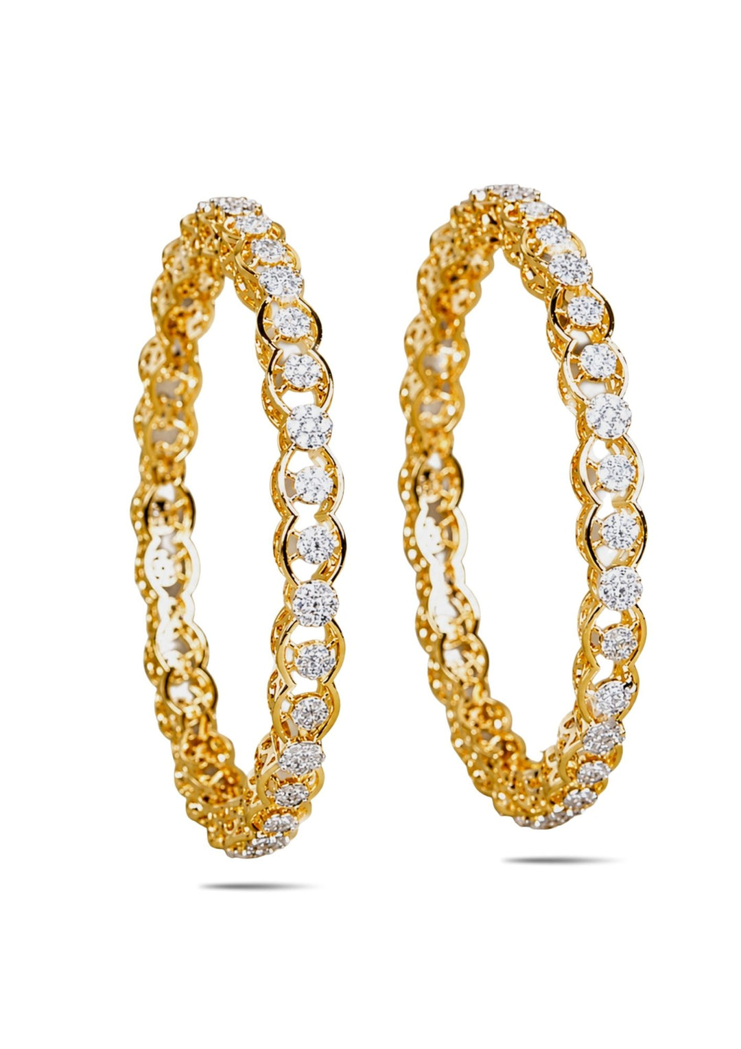 Gold plated bangles with diamond accents on a white background