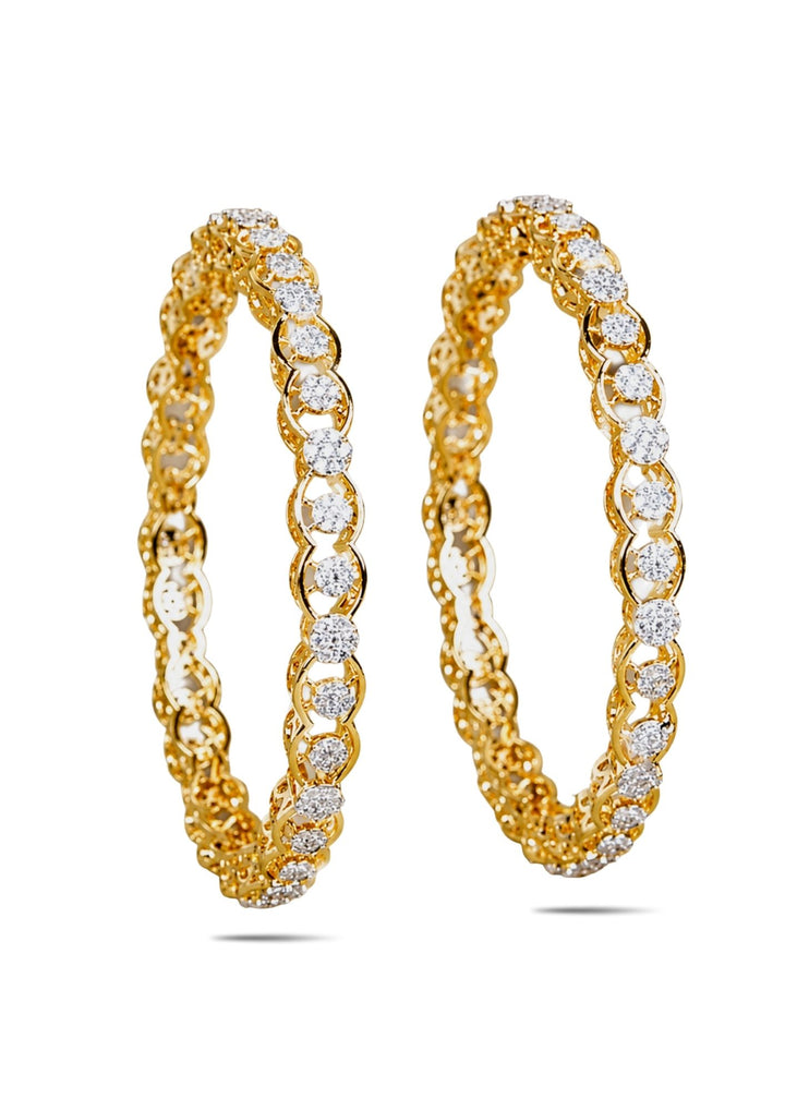 Gold plated bangles with diamond accents on a white background