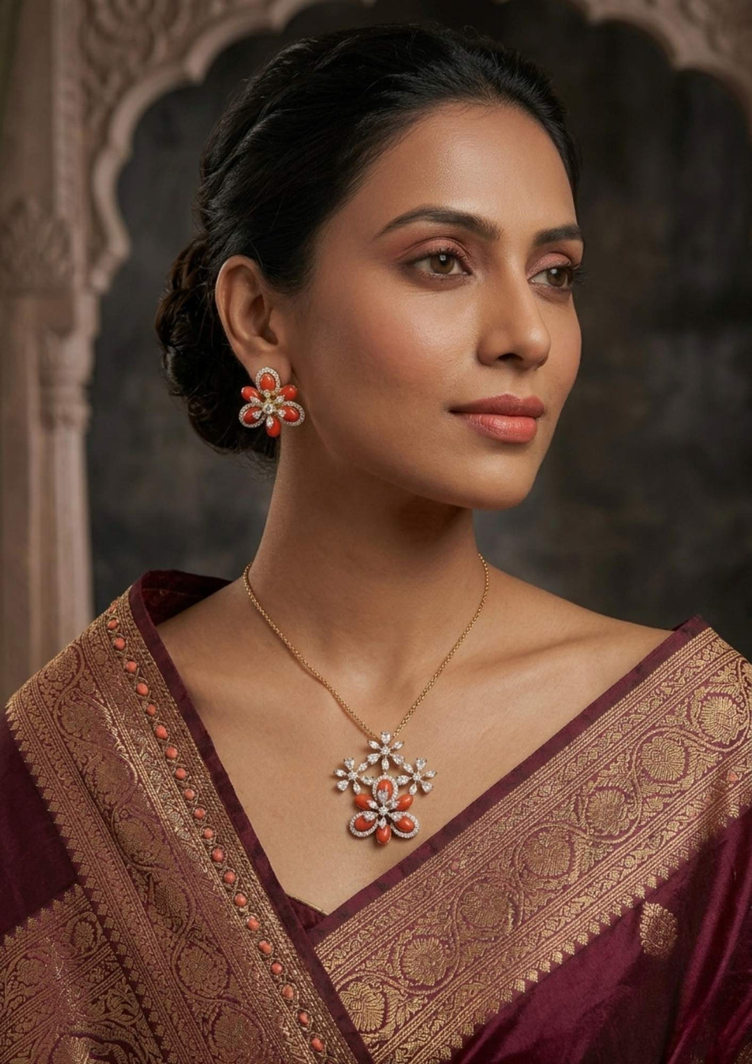 South Indian woman wearing Open Hook Pendant Gold Plated locket and matching earrings with red floral stone design and sparkling zircon detailing that gives a stylish and elegant jewelry look. The pendant shows detailed flower branch pattern while the earrings feature matching floral petal design with lightweight comfort, sweat proof finish, anti-fade colour, and smooth fitting suitable for parties, office wear, and festive occasions.
