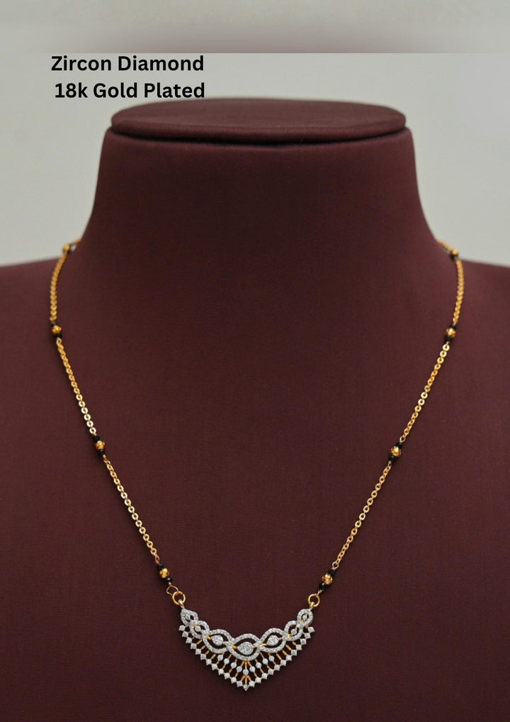 Modern Zircon Diamond gold plated mangalsutra necklace The design features a delicate gold link chain transitioning into sections of traditional small black beads on both sides. The central pendant showcases a sleek, contemporary curved V-shape and a stylized butterfly or floral motif encrusted with sparkling white cubic zirconia stones. This elegant neckpiece perfect for daily wear, office wear, and casual outfits.