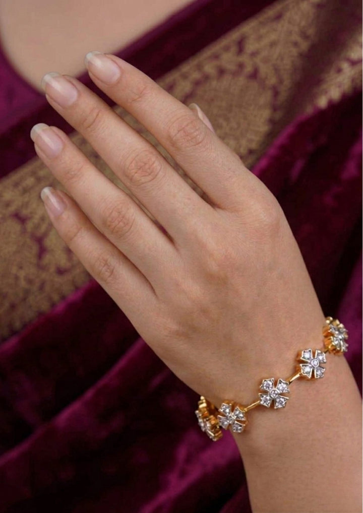 south indian women wearing a gold plated flower bangles come with zircon diamond and in picture shows clearly how it looks looks very classy and simple and ani faded and skin safe and can be used for daily ware, office ware and festivals
