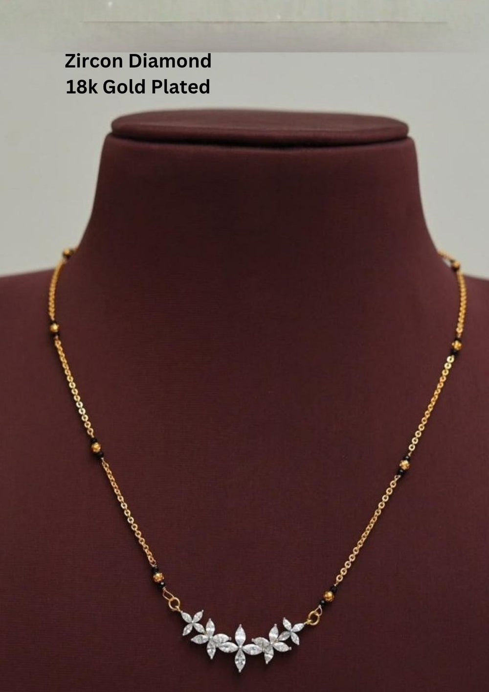 Gold plated black beads mangalsutra featuring an elegant Flower Model classic-inspired zircon centerpiece with delicate curved detailing. Lightweight and beautifully crafted for everyday elegance, festive occasions, and gifting.
