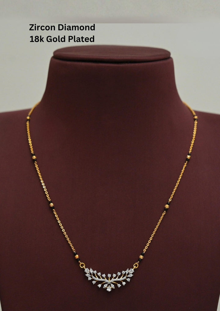 Gold plated black beads mangalsutra featuring an elegant lotus Model-inspired zircon centerpiece with delicate curved detailing. Lightweight and lotus model crafted for everyday elegance, festive occasions, and gifting.