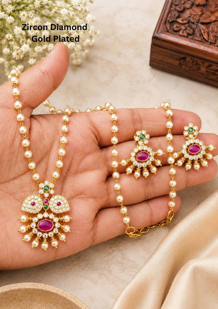 Zircon Diamond Gold Plated Neclace designed with pink and green stones abd white pearl hangings with  flower and doom shaped  design it is Lightweight, Anti-Tarnish, Perfect for dailywear, weddings &amp; festivals. 