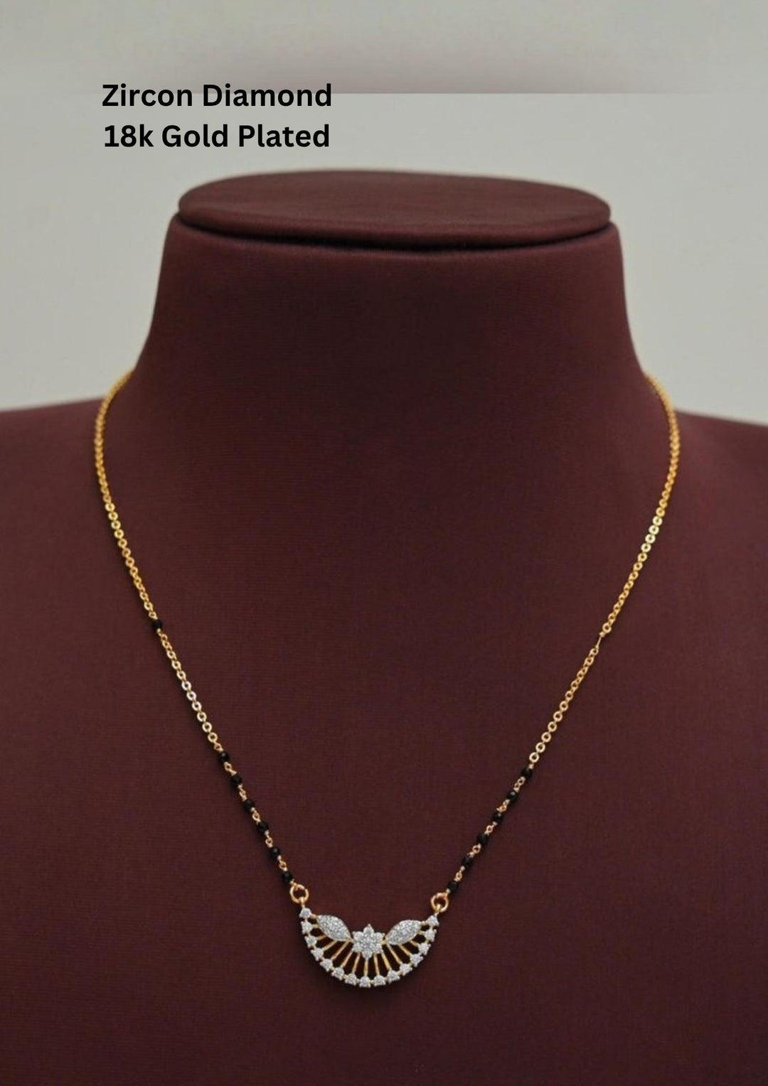 Gold plated black beads mangalsutra featuring an elegant Semi Curve-inspired zircon centerpiece with delicate curved detailing. Lightweight and beautifully crafted for everyday elegance, festive occasions, and gifting.