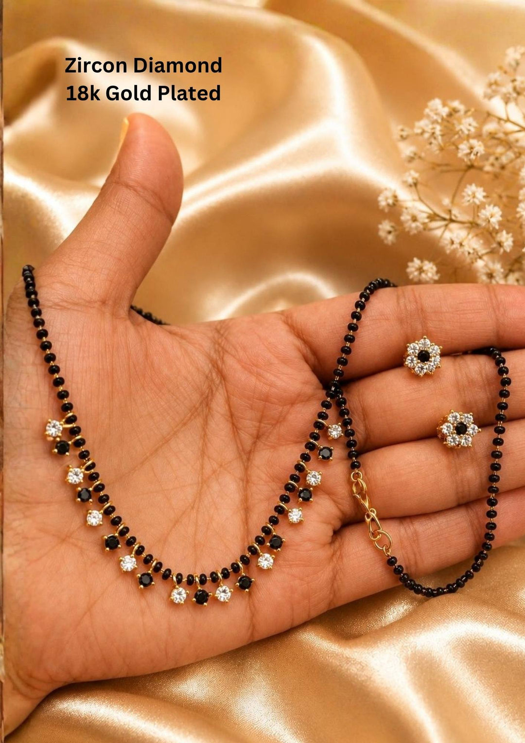 Zircon diamond 18k gold-plated necklace and earrings designed with single line nallapusalu black beads with white and black stones hanging and with matching studs perfect for daily wear and office wear and its anti fade color