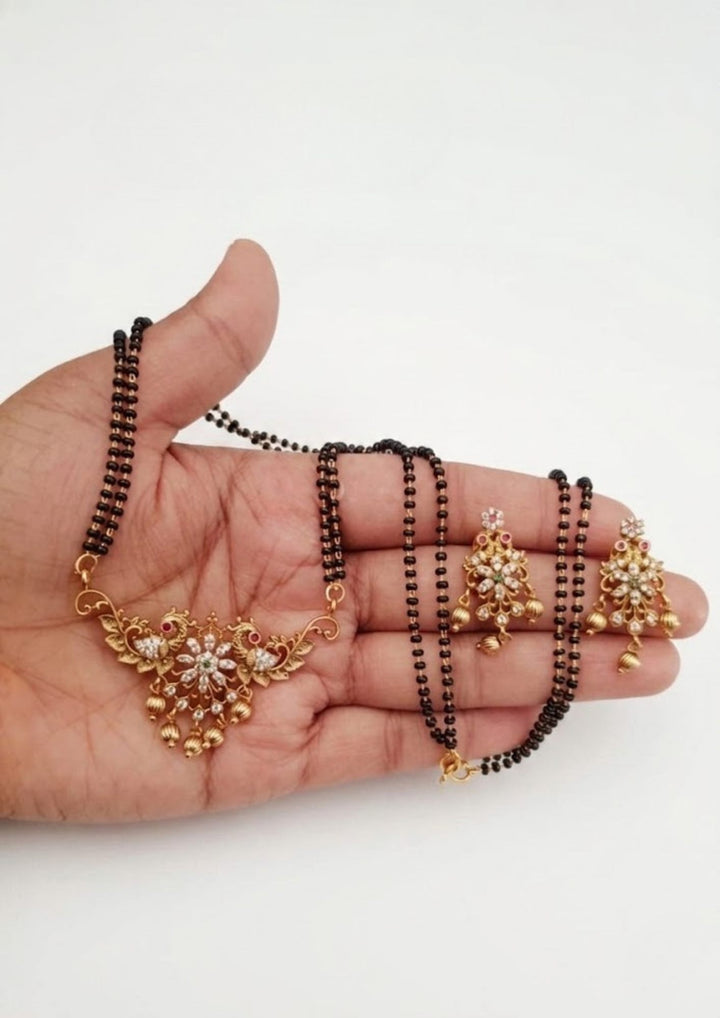 Zircon Diamond Gold Plated Mangalsutra (nallapusallu)with Earrings with White Background looks very elegant with peacock design 