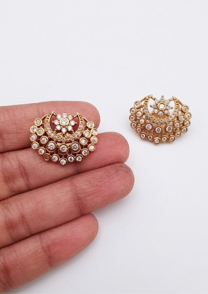 gold plated zircon diamond studs which shows in white background and in earrings shown very clear in picture and also in image it shows as in half moon shape and it called polki studs and can use for daily ware, office ware , and for gifting
