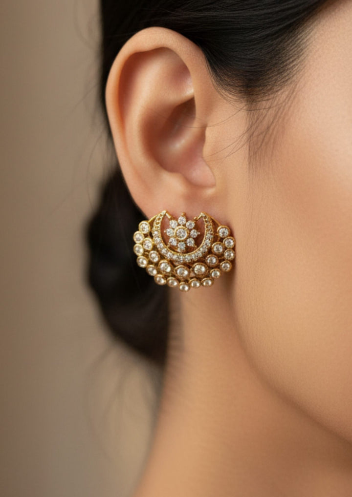 close-up view of a south Indian women wearing a polki studs in the shape of half moon with white zircon diamonds.and can use for traditional , office ware , daily ware and for gifting 