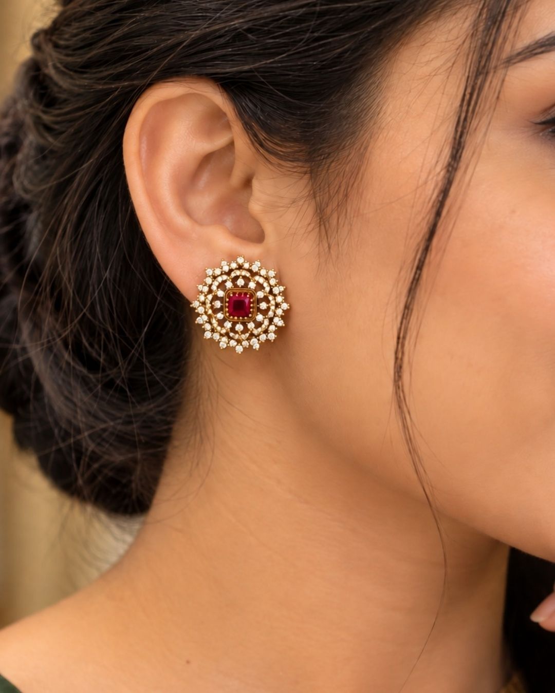 Gold-plated jewelry set with interchangeable stones with purple, pink, green. ornate studs with a gold-toned base. They are heavily embellished with multiple rows of glittering white stones (likely American Diamonds or CZ stones) arranged in a sunburst or floral pattern.