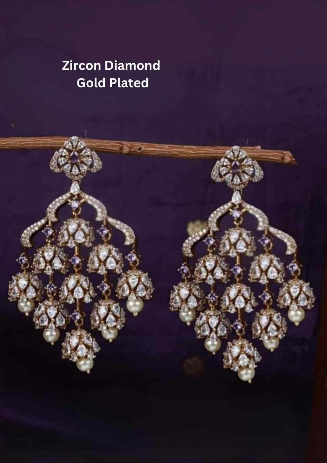 Zircon diamond gold plated blue Chandbali Long Earrings with hanging guttapusalu design, sparkling white zircon stones, floral pattern detailing, and elegant layered arrangement finished with shiny gold plating. The earrings come with lightweight, sweat proof quality, anti-fade colour, skin-friendly finish, and are suitable for weddings, receptions, festivals, functions, and party wear 