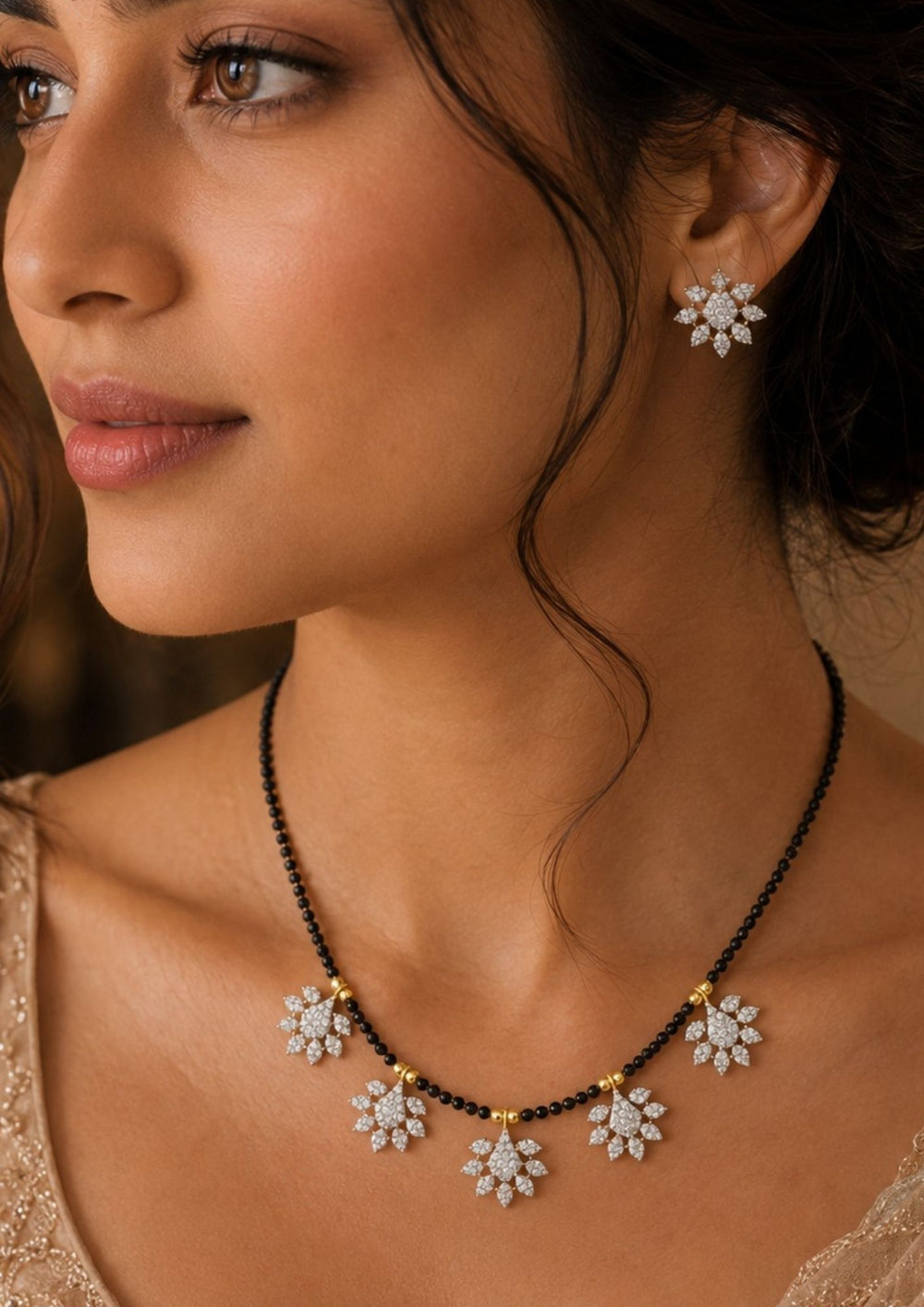 South indian women wearing a Modern Zircon Diamond gold plated mangalsutra necklace The design features a delicate gold link chain transitioning into sections of traditional small black beads on both sides. The central pendant showcases a sleek, contemporary curved Tear drop pendant with sparkling white cubic zirconia stones. This elegant neckpiece perfect for daily wear, office wear, and casual outfits.