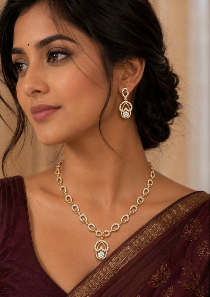 South indian women wearing a Stylish Zircon Diamond gold plated necklace set featuring an elegant oval link design with matching dangling earrings. Perfect for parties, weddings, festive occasions, and gifting.