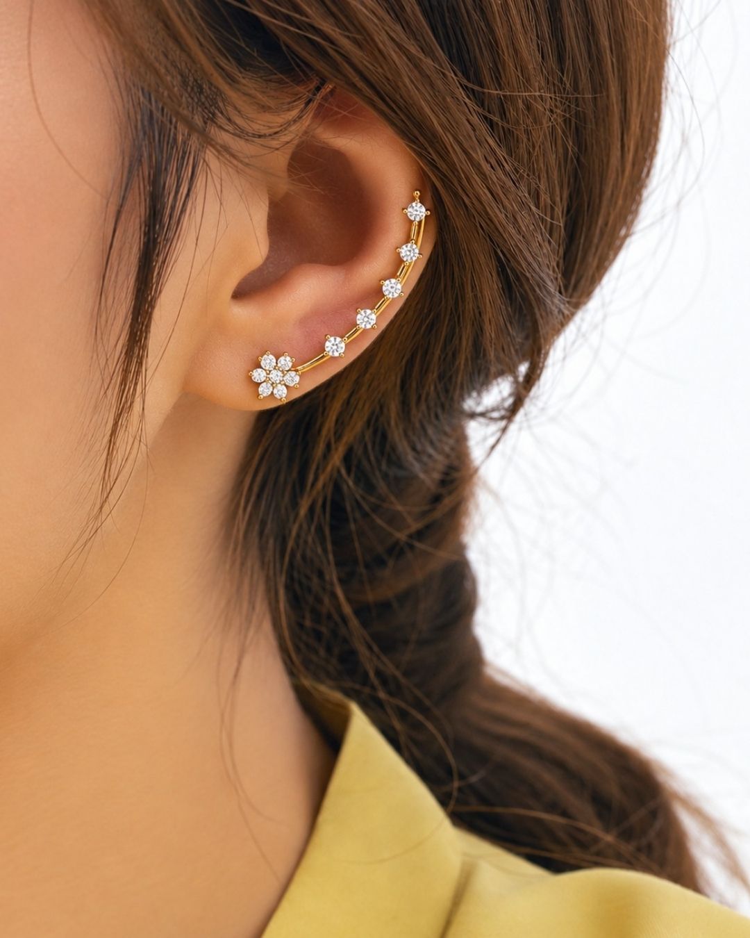 Stylish open gold plated ear cuff decorated with sparkling zircon stones, perfect for modern and festive looks.
