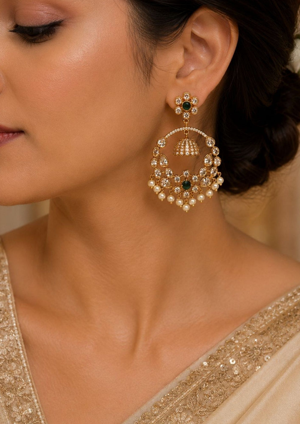South indian women weaing Zircon diamond gold plated green Chandbali Long Earrings with hanging guttapusalu design, sparkling white zircon stones, floral pattern detailing, and elegant layered arrangement finished with shiny gold plating. The earrings come with lightweight, sweat proof quality, anti-fade colour, skin-friendly finish, and are suitable for weddings, receptions, festivals, functions, and party wear .