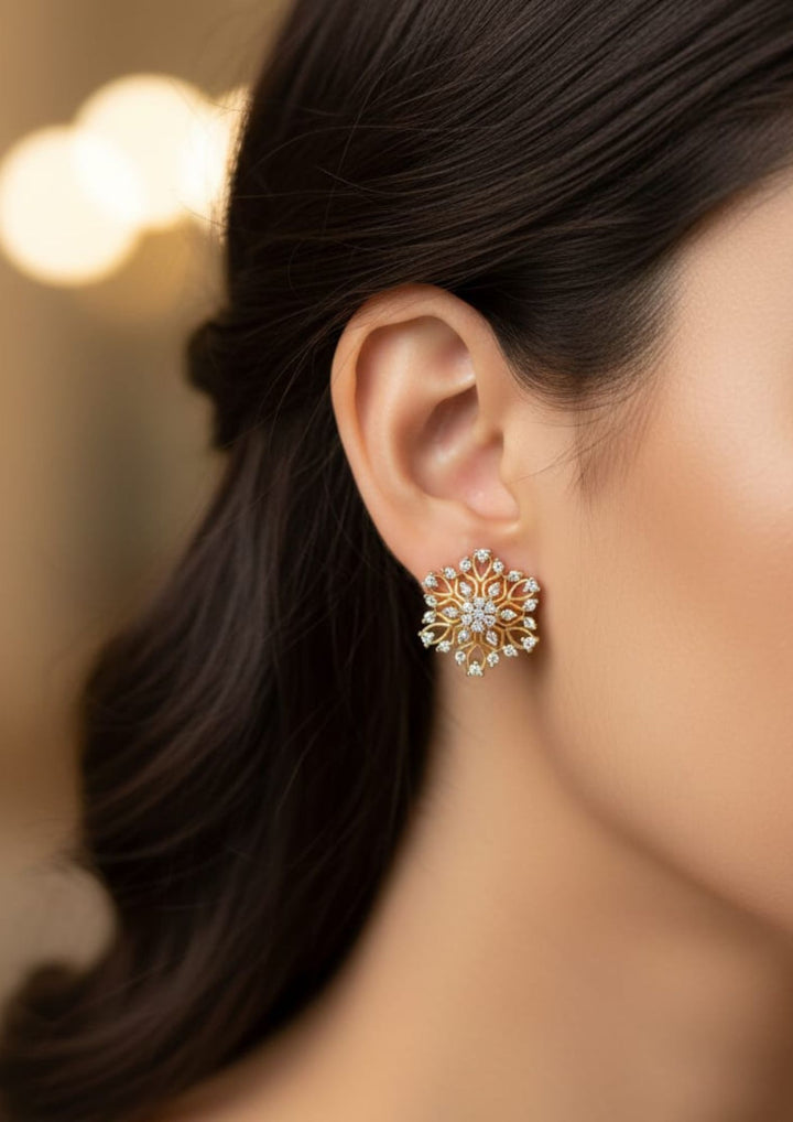Close-up of South Indian  Women wearing a Gold Plated Zircon Diamond Studs showcasing a detailed floral pattern with fine gold wirework and set white zircon stones. These lightweight, skin-friendly ear studs feature an anti-fade, sweat-proof finish, making them a perfect, choice for weddings, festivals, and parties nd dailywear