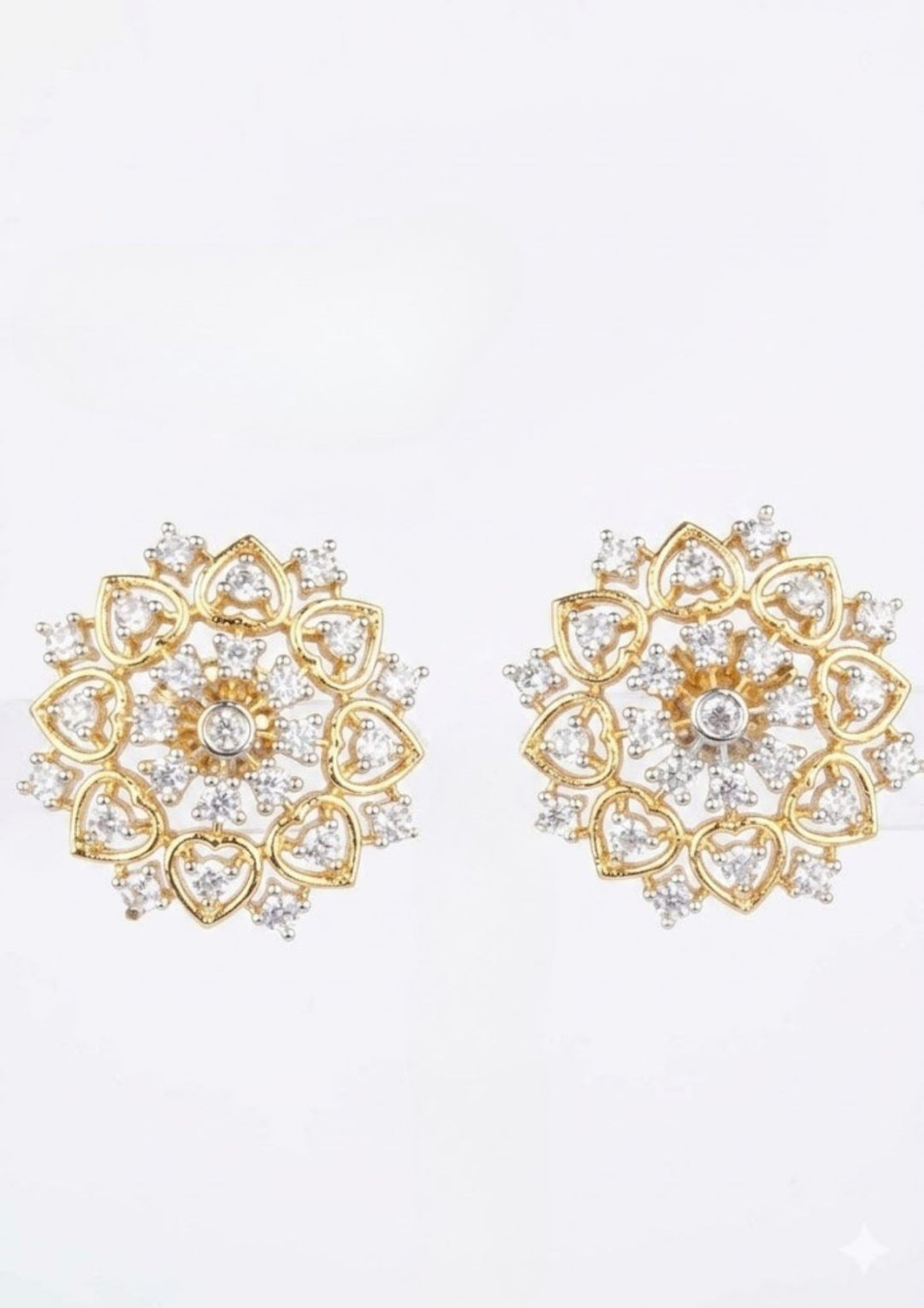 Gold plated studs with delicate design  and diamond heart shape on white background detail for dailyware , festivals and officeware used for south Indian festivals