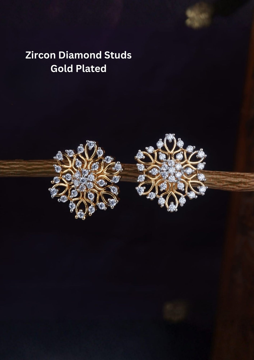 Zircon Gold Plated Diamond Studs designed with snowflake and floral-shape. The earrings are sparkling with white zircon stones completed by gold loops, each tipped with a shimmering diamond stone for a luxurious, high-shine jewelry look Perfect for festive wear,daily wear.