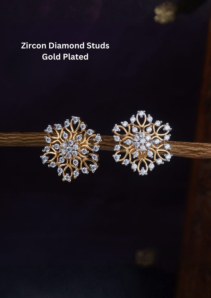 Zircon Gold Plated Diamond Studs designed with snowflake and floral-shape. The earrings are sparkling with white zircon stones completed by gold loops, each tipped with a shimmering diamond stone for a luxurious, high-shine jewelry look Perfect for festive wear,daily wear.